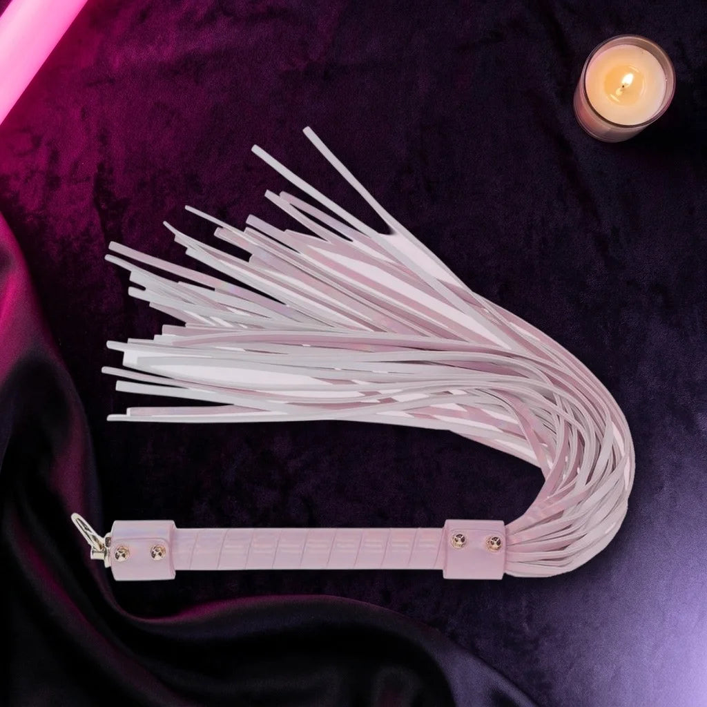 Pale pink leather flogger on dark purple velvet
